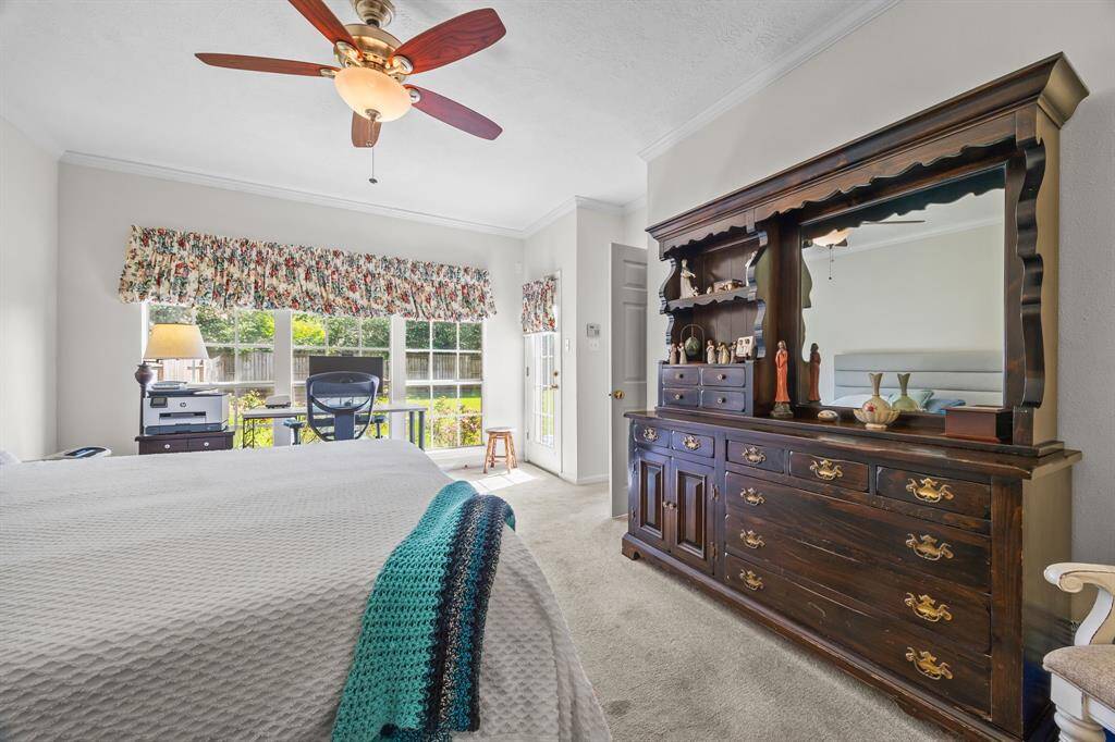 Spacious primary bedroom with room for a seating area or office, plus direct backyard access.