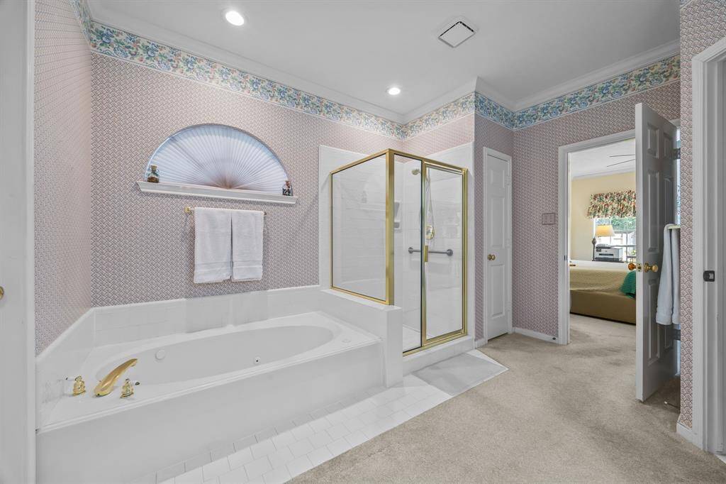 Indulge in the primary bathroom's spacious jacuzzi tub and separate shower.
