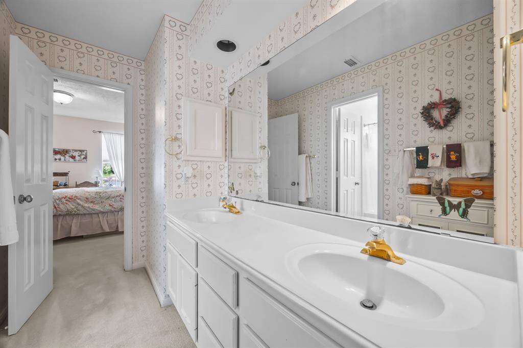 Elegant Jack and Jill bathroom with double sinks and ample storage.