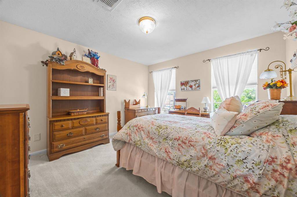 Bright third bedroom with front-facing views and abundant natural light.