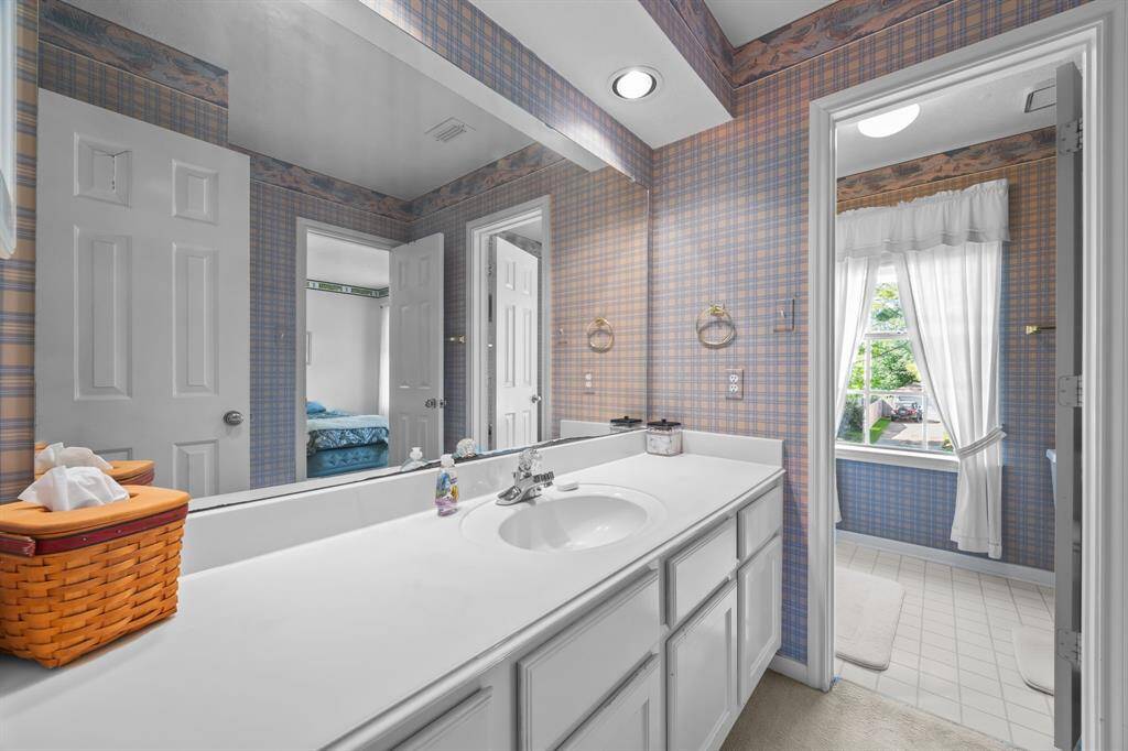 Spacious hall bathroom with ample counter space and abundant storage.