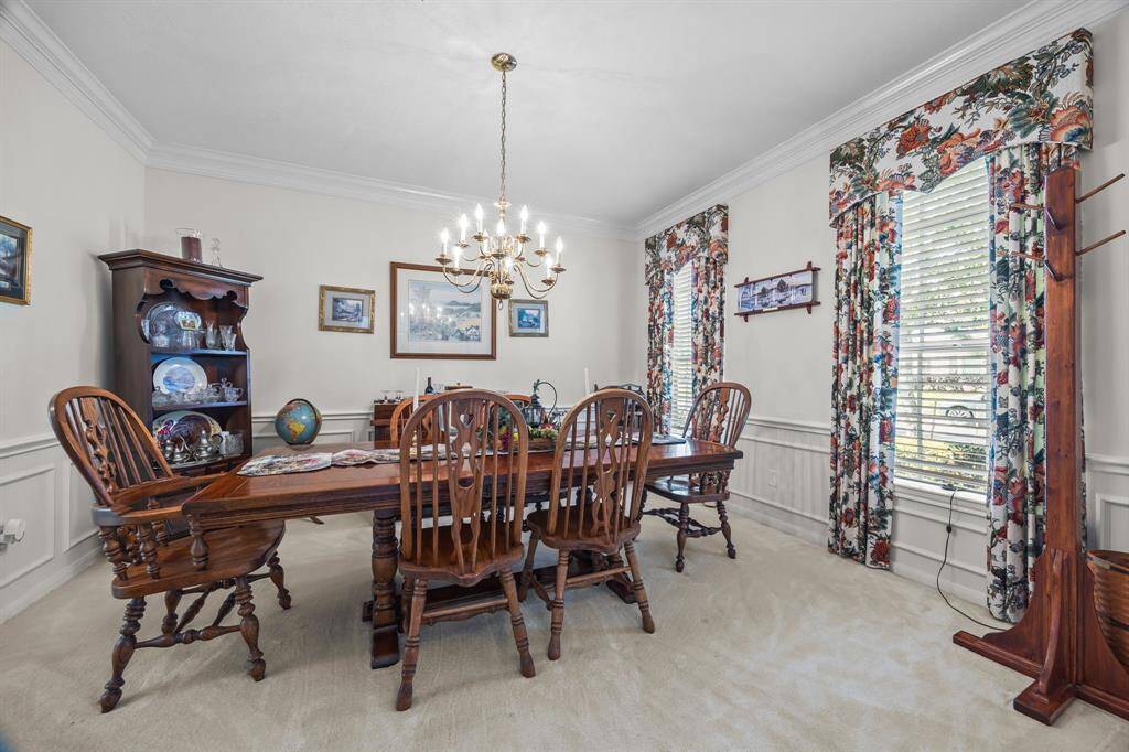 This spacious dining room is bathed in natural light, perfect for hosting your summer gatherings.