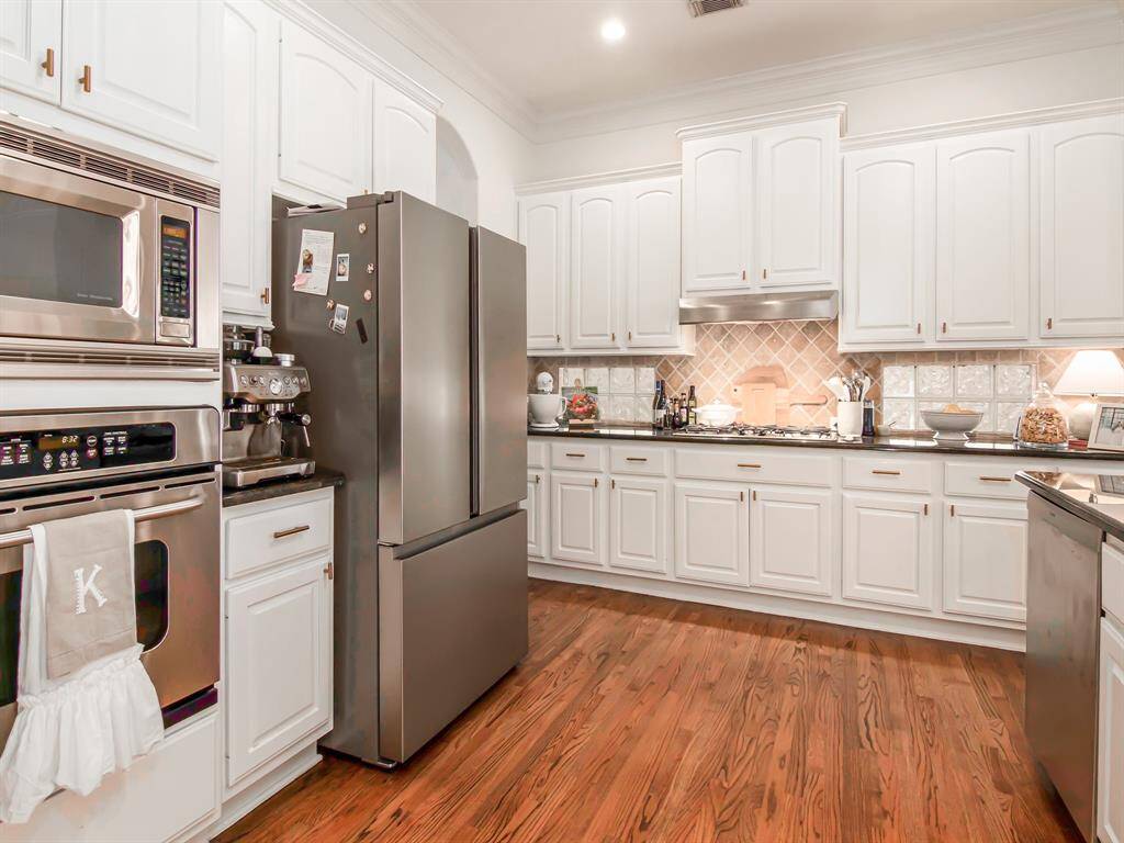 Stainless Steel appliances and gold knobs.