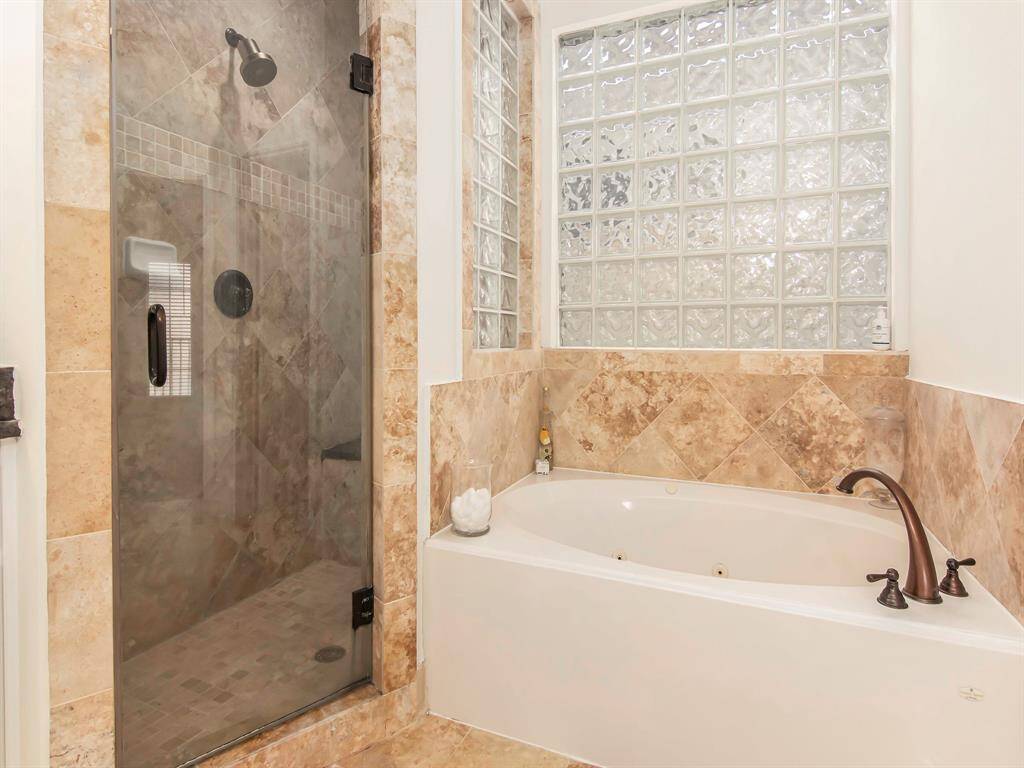 Shower with a bench with jacuzzi tub.