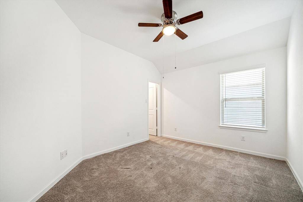 Secondary bedroom #1 features a walk-in closet and hallway access to the secondary bath.