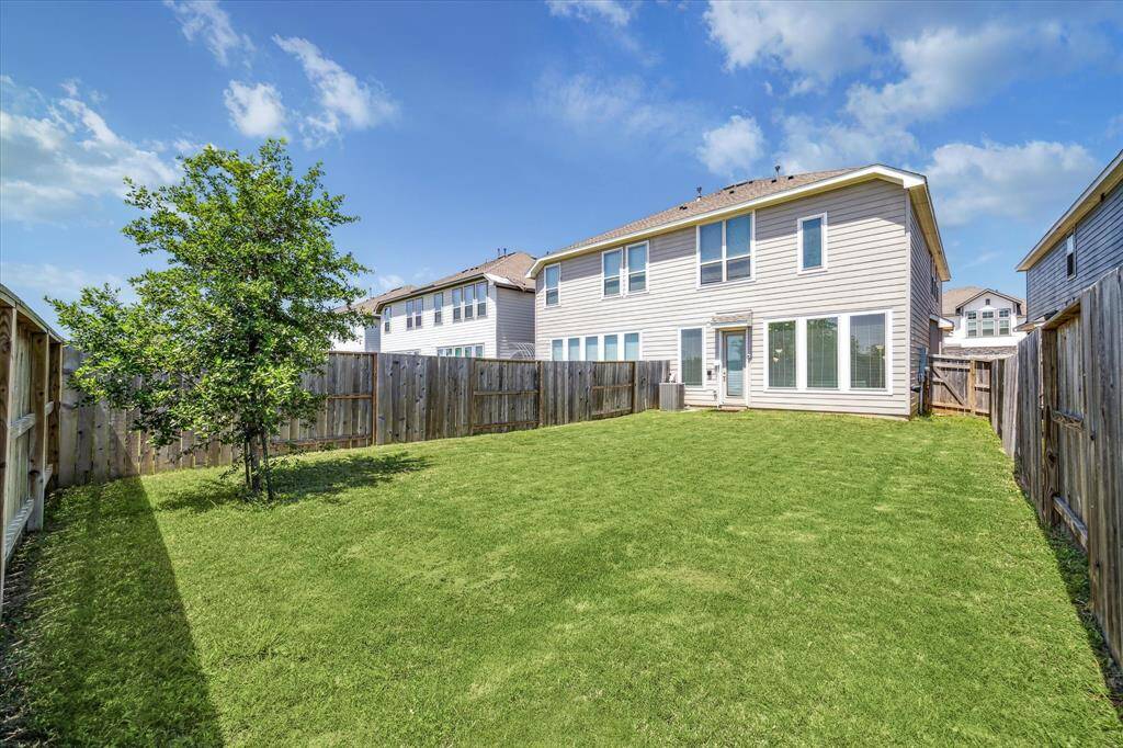 The spacious back yard includes an automatic sprinkler system for easy lawn maintenance.