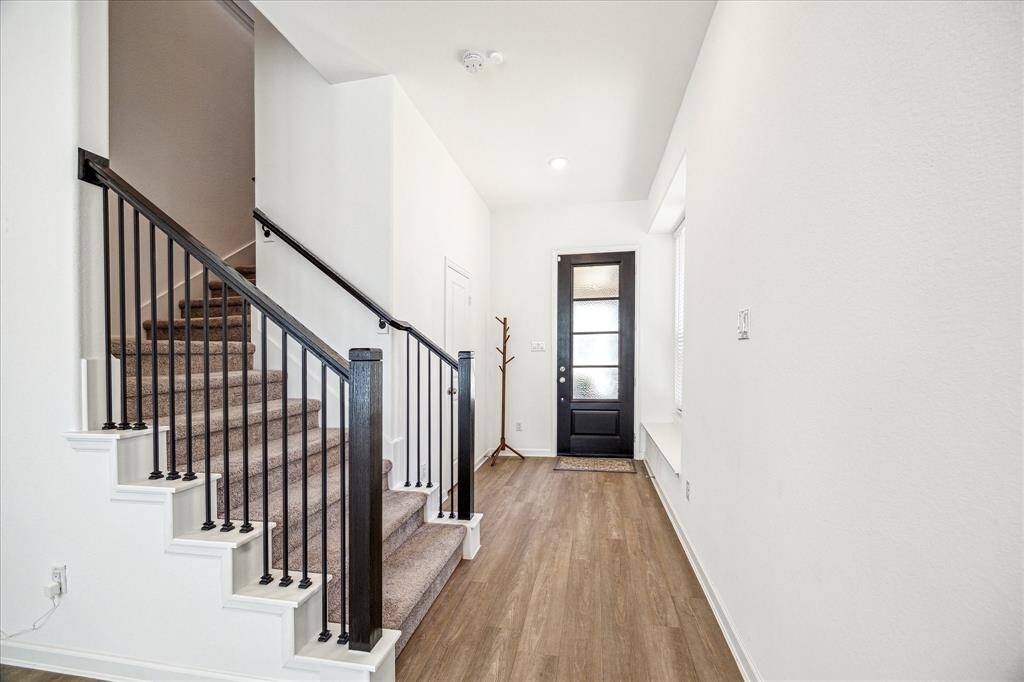 A half-bath is located just off the entryway. Stairwell access leads to 2nd-floor bedrooms, game room, and utility room.
