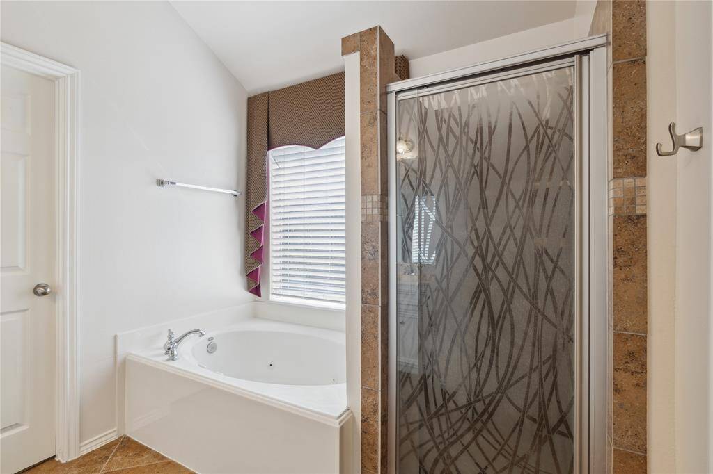 The primary bathroom conveniently leads into a spacious walk-in closet, offering a seamless flow and added functionality to your daily routine.