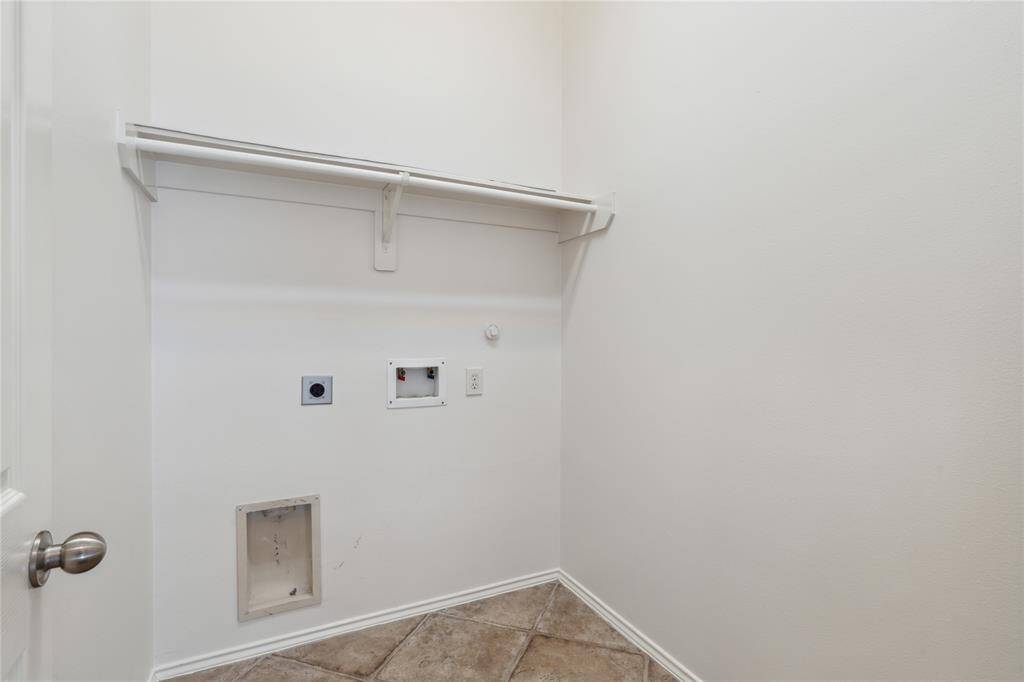 The utility room offers ample space for a full-size, side-by-side washer and dryer—making laundry day convenient and efficient.