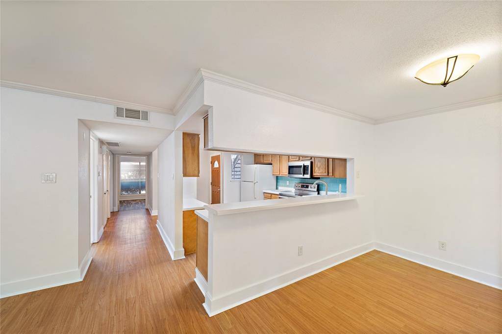 View of the kitchen bar and hallway to the bedrooms.