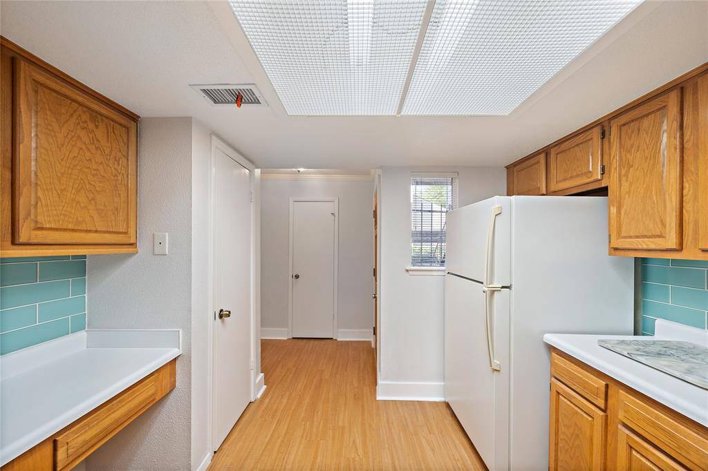 This kitchen a lot of storage space and a pantry.