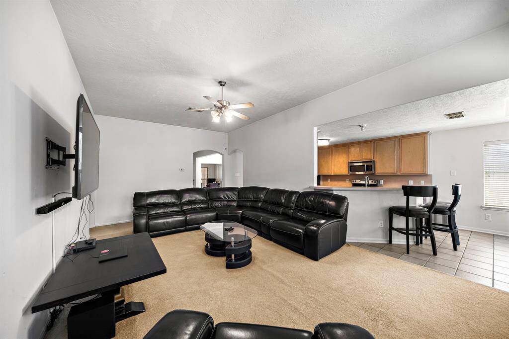 Spacious living area with easy access to the kitchen.