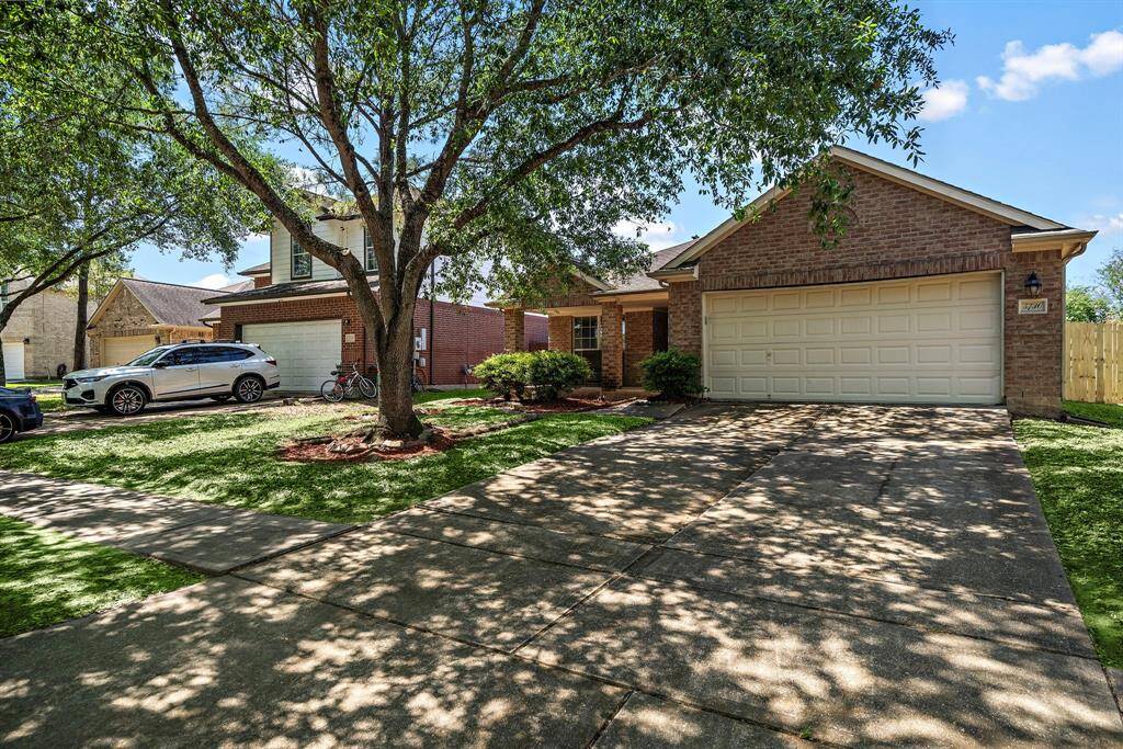 Home featuring a two-car garage and a spacious driveway