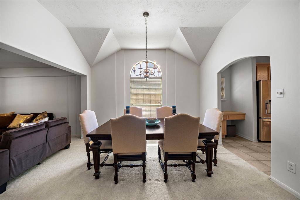 Formal dining room with vaulted ceilings