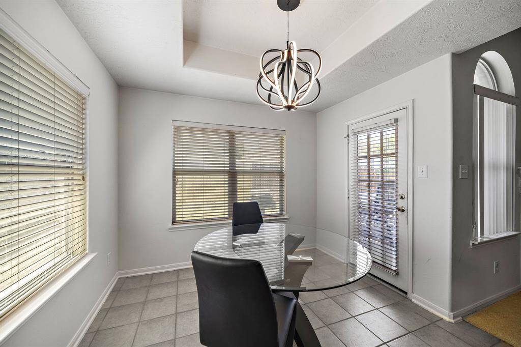 Dining area with natural light and convenient access to the backyard.