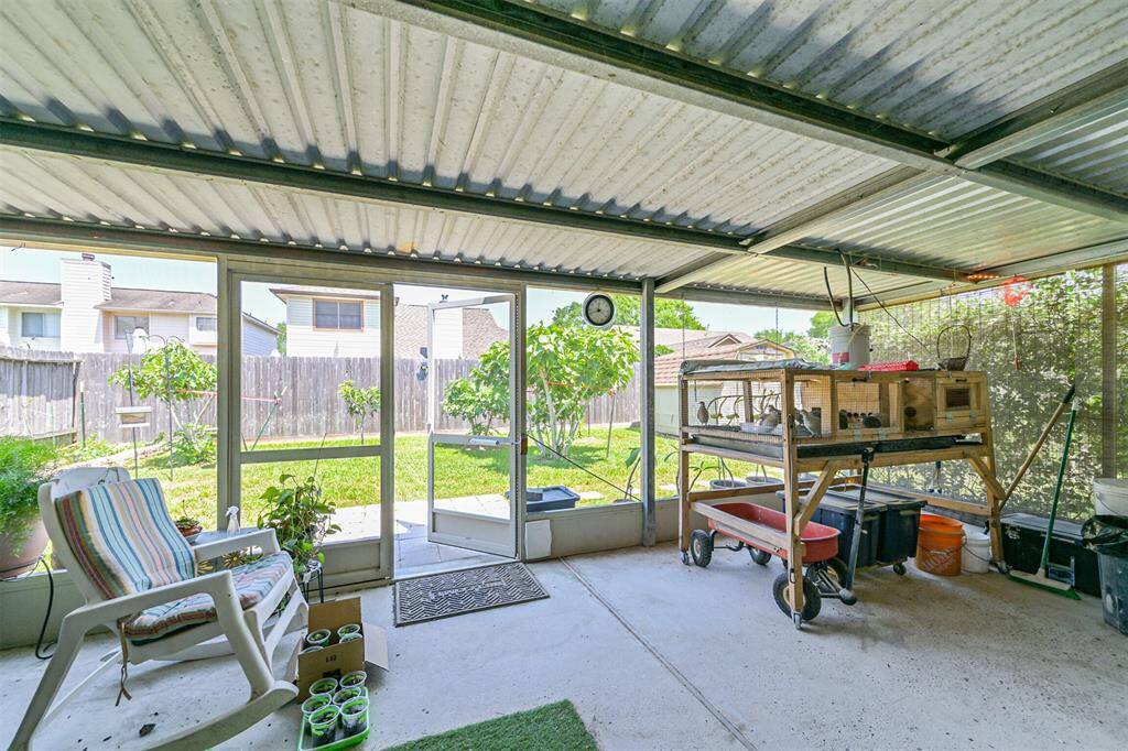 Covered patio extension with French drains, mature fig and loquat trees, and fenced yard with room to play or garden.