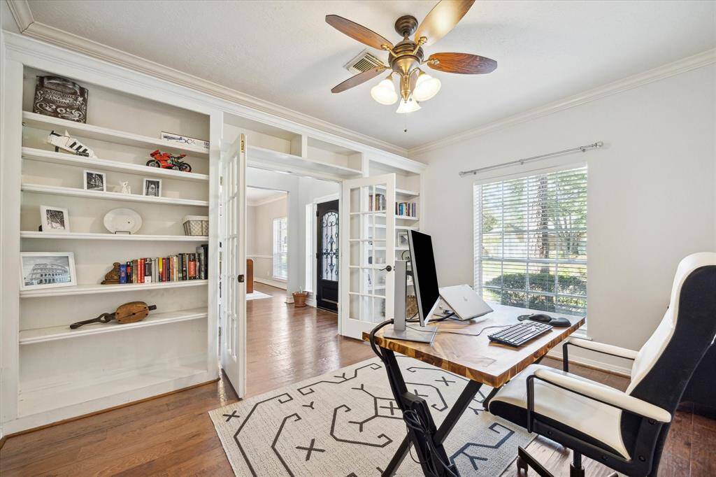 French doors lead to your office complete with built-in shelving