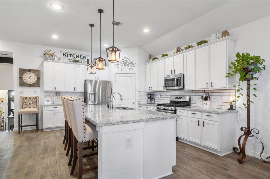Plenty of lighting and large island space to entertain in this kitchen.