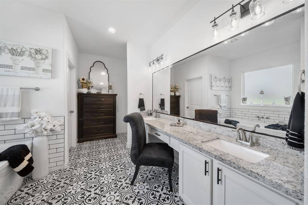 Your primary bathroom includes dual sink space and a large vanity area.