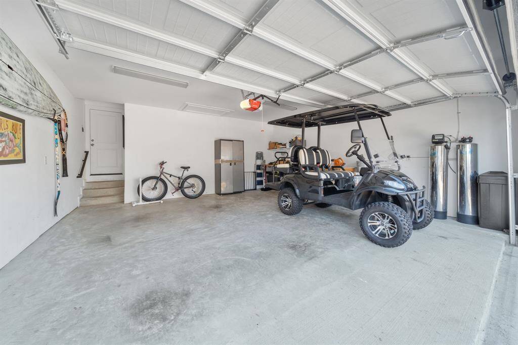 Very Spacious garage with workbench, storage and space for two cars or your golf cart and vehicle.