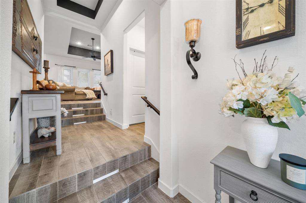 Large open entry way with a landing to enter the garage or utility room, kept separate from the living space.