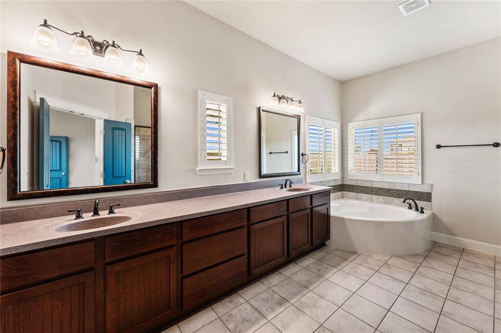 Dual sinks ensure both partners have a dedicated area for grooming and self-care! Ample counter space is only enhanced by the tremendous space beneath, which includes multiple drawers of varying sizes and base storage cabinetry!