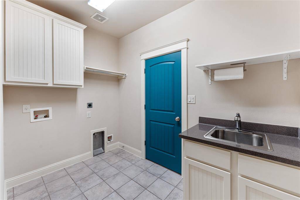 The utility room includes a sink with storage for cleanliness and tidy function. Place cleaning supplies beneath for easy and quick access.