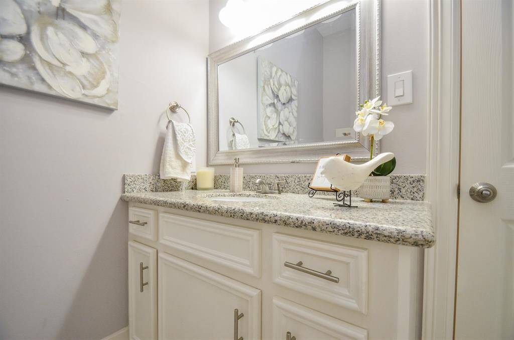 Bathroom with granite countertop located next to the front bedroom.