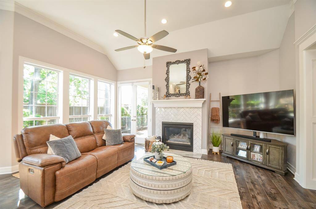 Light filled family room with soaring 12' ceilings and chic fireplace.