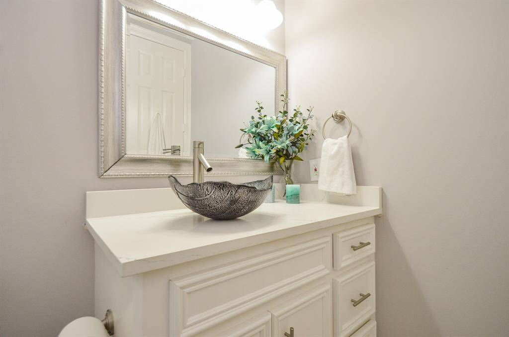 Private bathroom attached to guest suite with new quartz countertop, sink, and faucet.