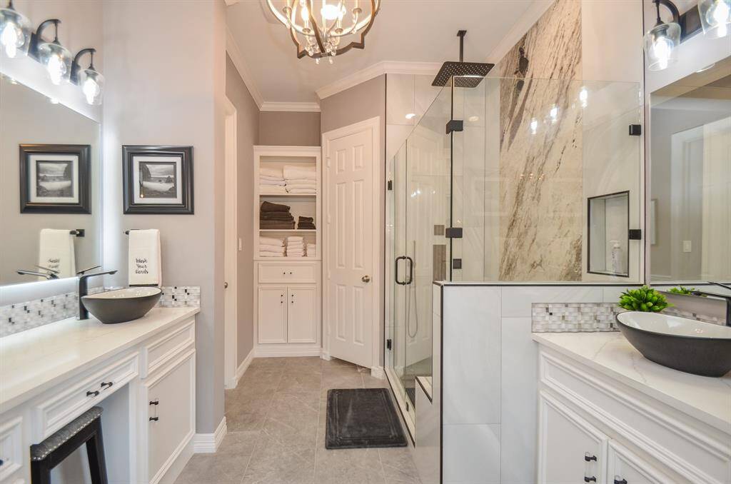 Completely remodeled primary bathroom looks like something out of a magazine! It features a private toilet room and two walk-in closets!