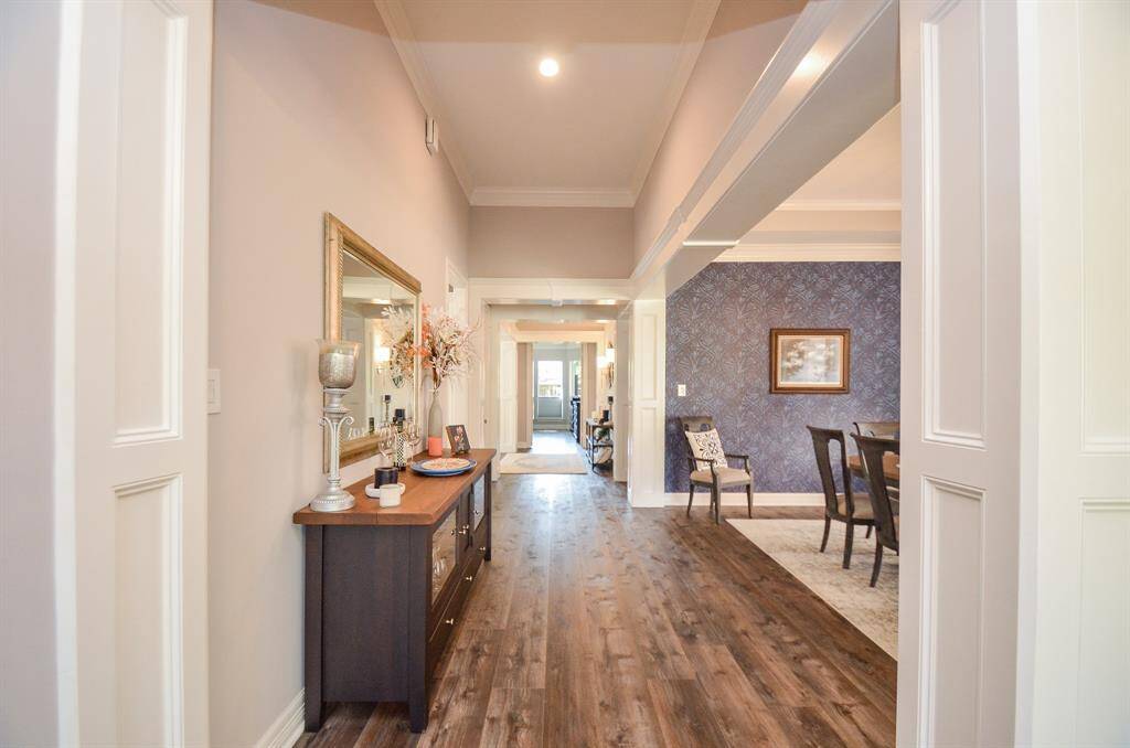 Impressive crown molding and millwork throughout. Notice the new luxury vinyl plank flooring!