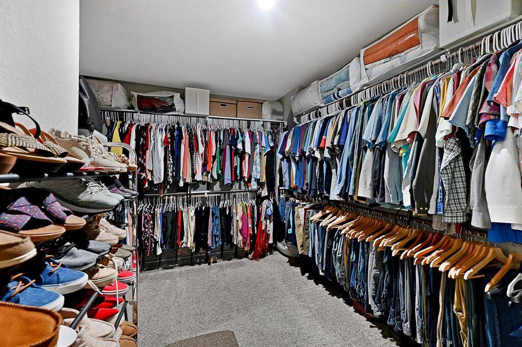 Spacious primary walk-in closet.