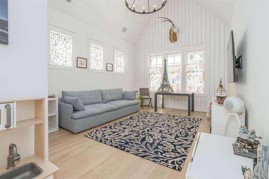 Spacious upstairs game room perfect for relaxation and entertainment.