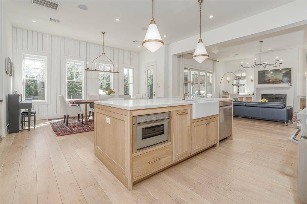 Open-concept kitchen and living area.  The living room is spacious with a cozy fireplace, offering a seamless flow perfect for entertaining.
