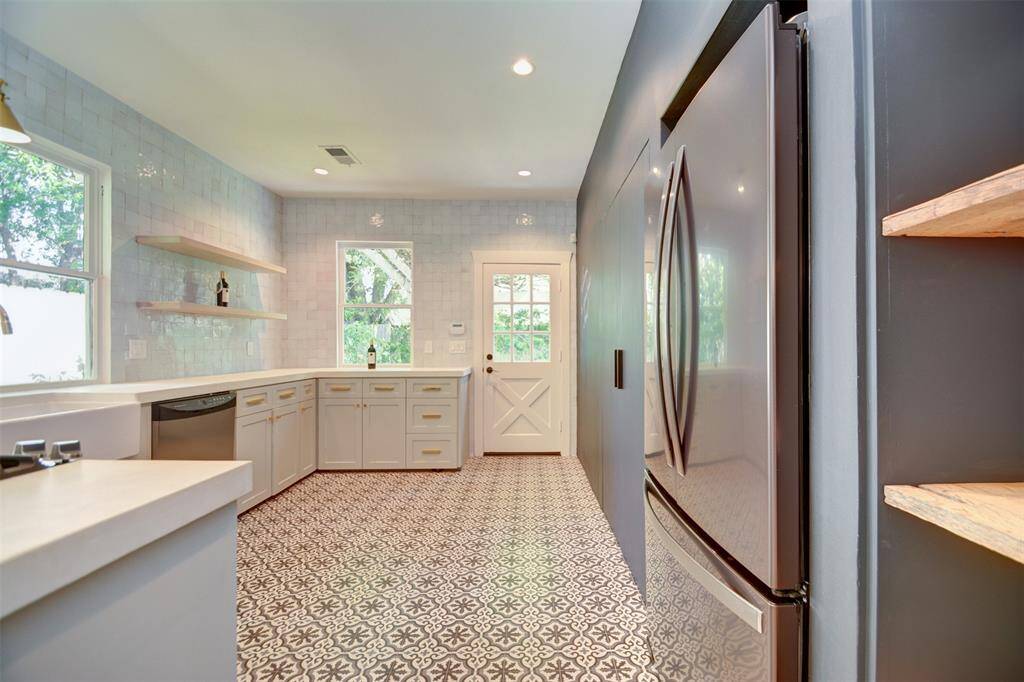 The modern kitchen connects to the backyard