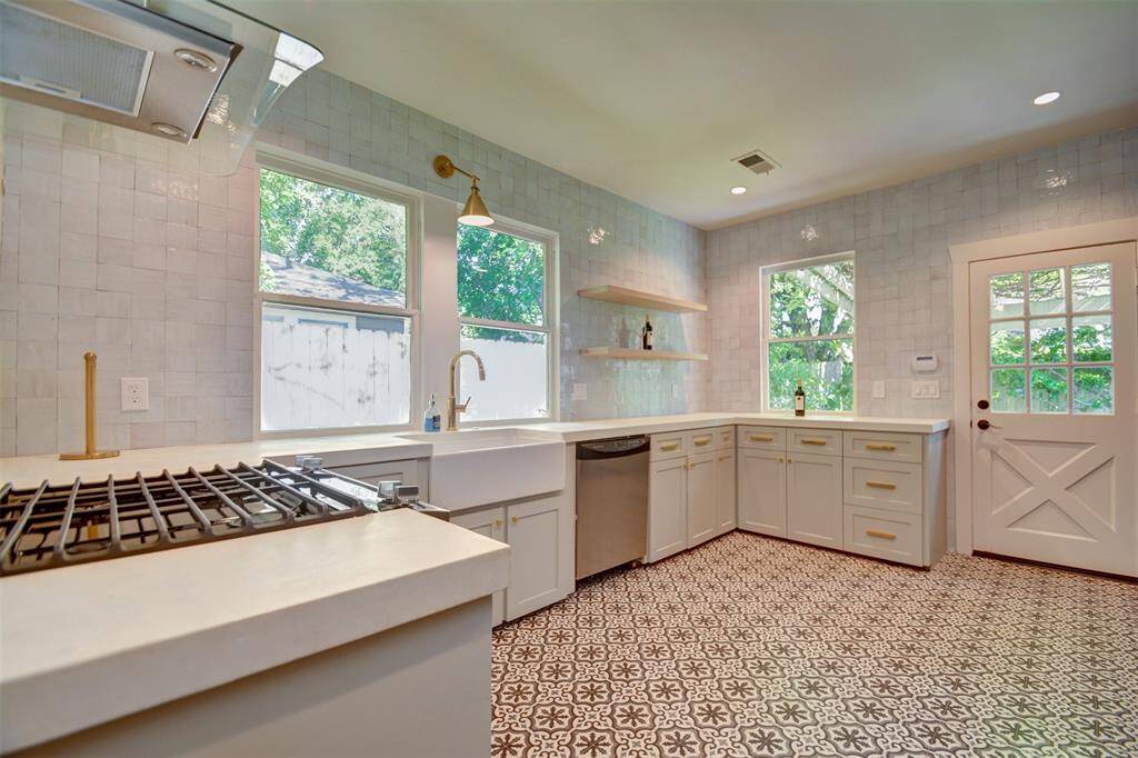 Zellige Kitchen backsplash, custom concrete countertops, concrete tile floors.