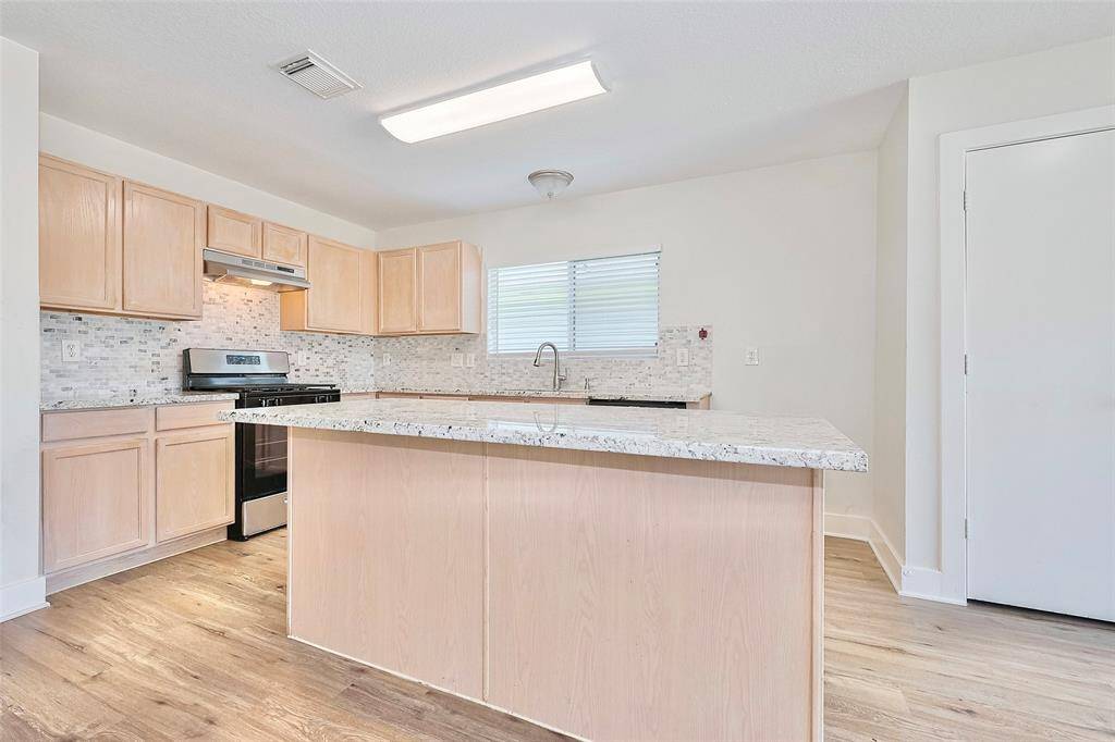 A head on view of the size of the kitchen island and kitchen space