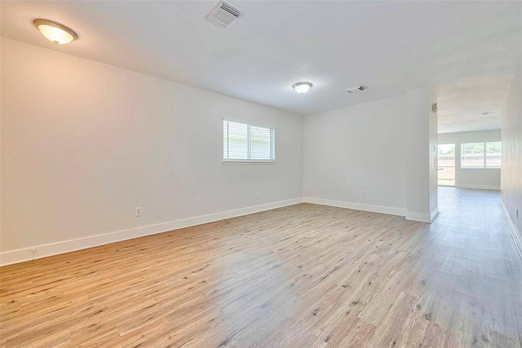 The formal dining room with a view of the walk way to the rest of the home