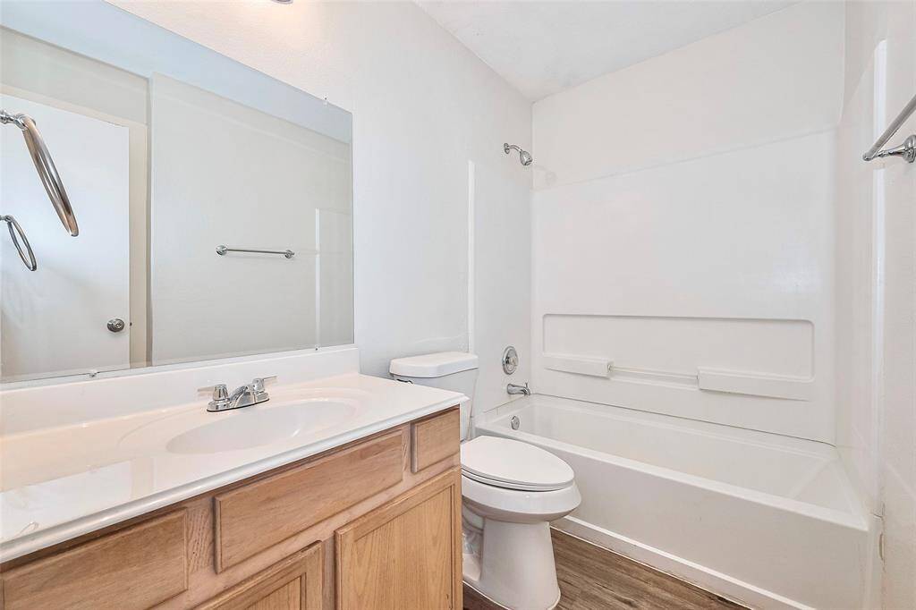 The secondary bathroom features a shower/tub combo.