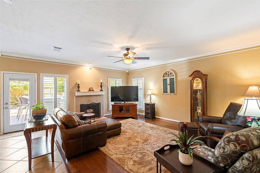 Family room with gas log fireplace and access to the backyard oasis.