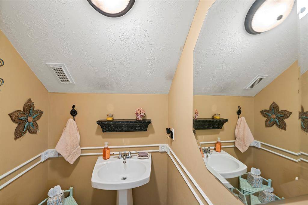 Downstairs half bath with pedestal sink.