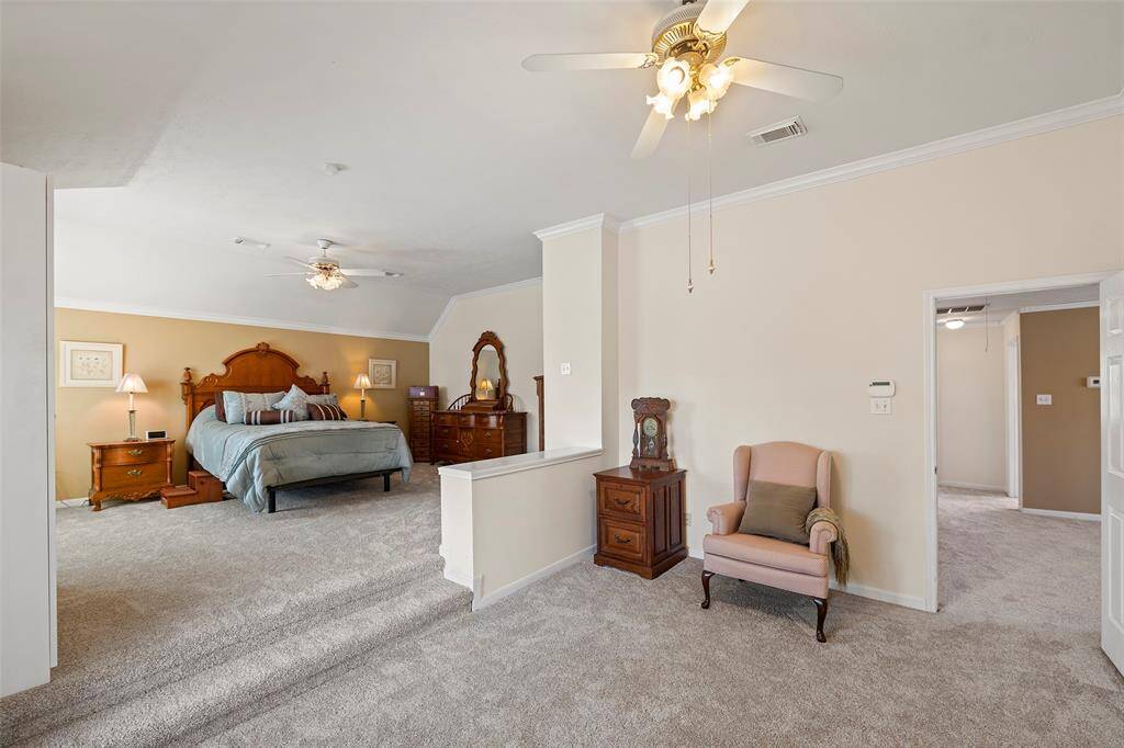 Primary suite has elevated bed area, large sitting area, and ensuite bathroom.