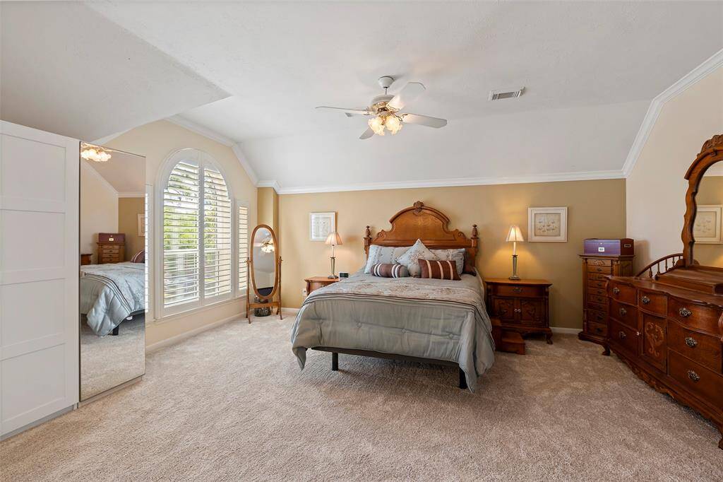 Primary suite has double pane windows, plantation shutters, and crown molding.