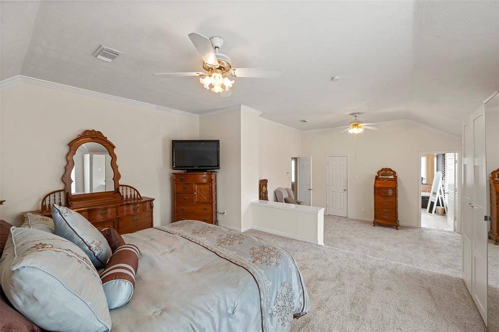 Primary sitting area with walk-in closet leads to the primary bathroom.