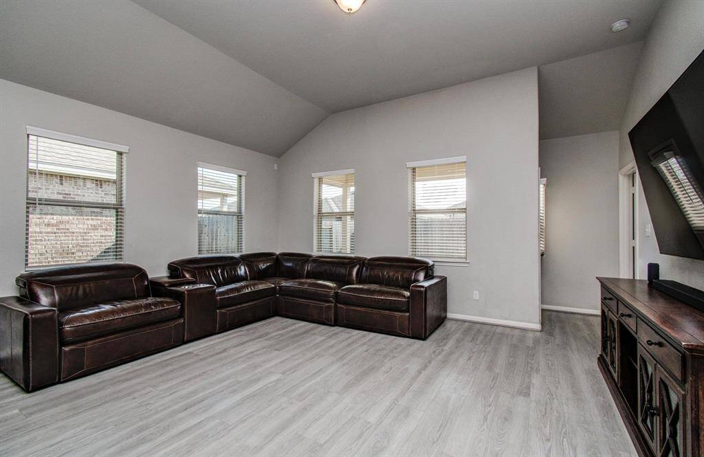 Family room w/ hallway leading to the primary suite