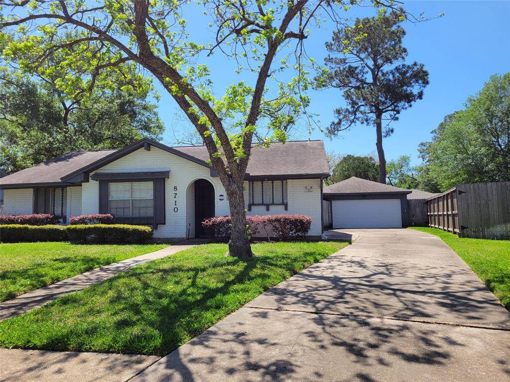 Long driveway leading to detached garage.
