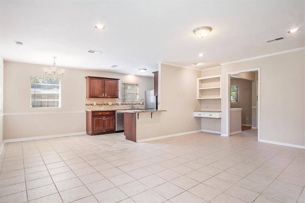 Updated galley kitchen opens up to dining and living combo.