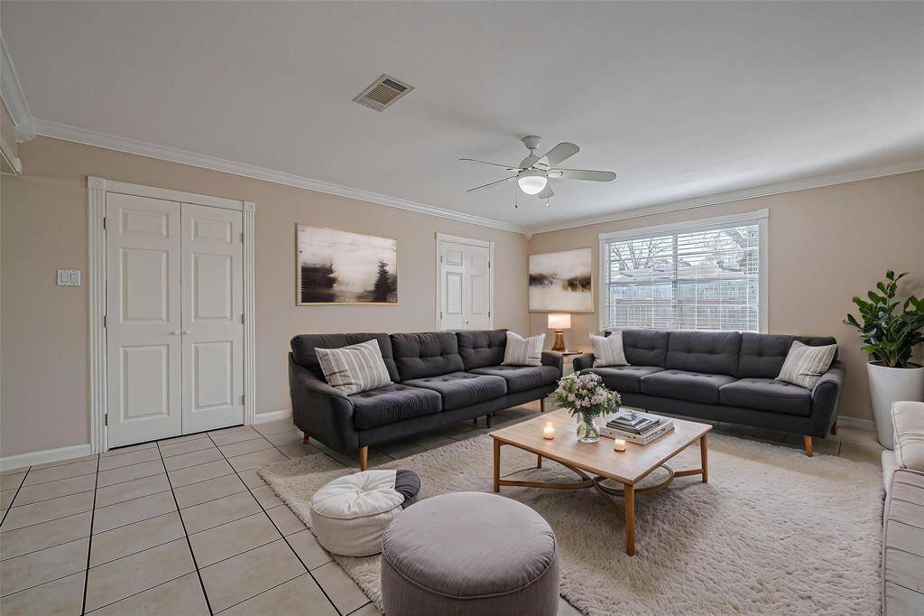 Another view of the living area, filled with lots of natural light and extra storage space. *Virtually Staged*