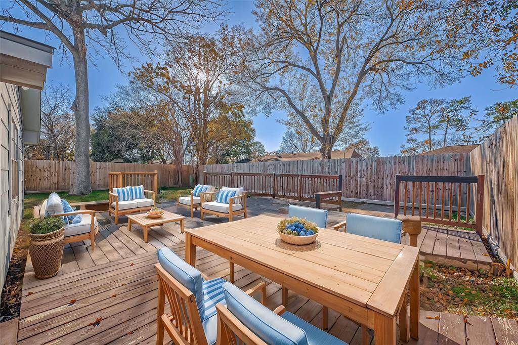 Spacious backyard with mature trees and oversized deck! *Virtually Staged*